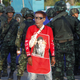 A member of the pro-government “red shirt” group walks past Thai soldiers at an encampment in Nakhon Pathom province on the outskirts of Bangkok.